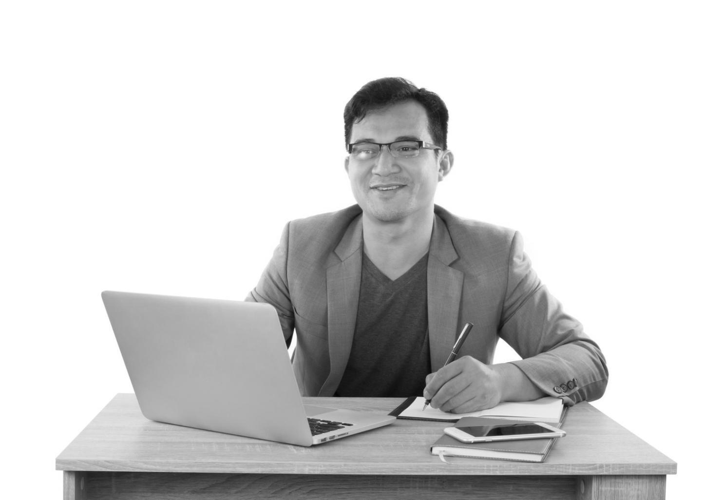Financial planning documents and charts spread across a desk with calculator and laptop