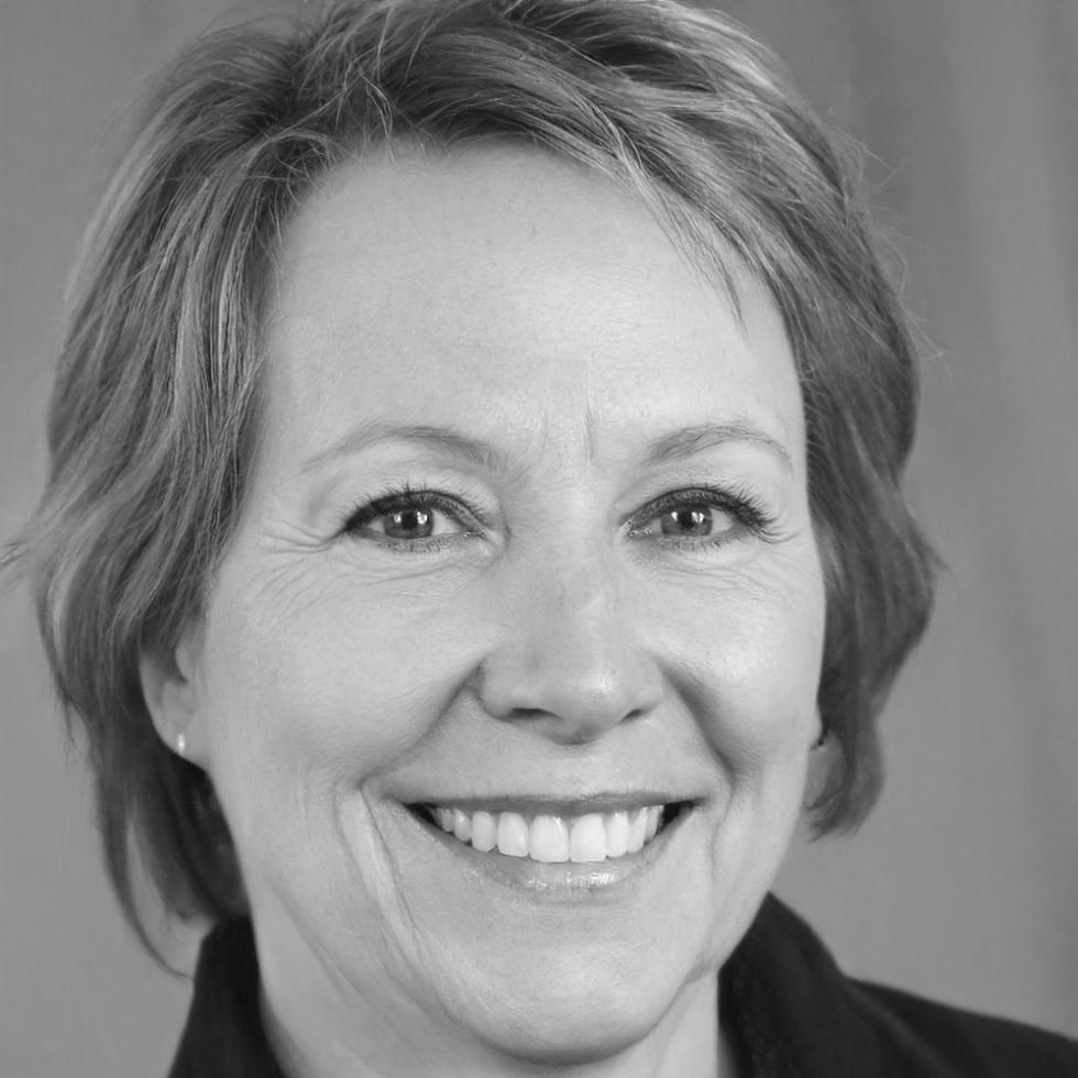 Professional woman in business attire smiling confidently