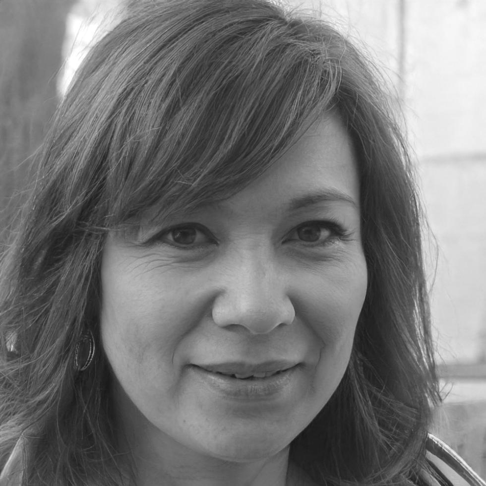 Professional woman reviewing financial documents at modern workspace